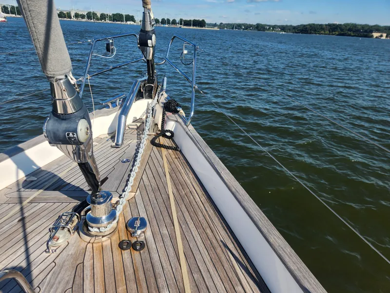 Slide: The Image of Deck view of a 2008 Hallberg-Rassy 62 sailboat on calm waters. - 6
