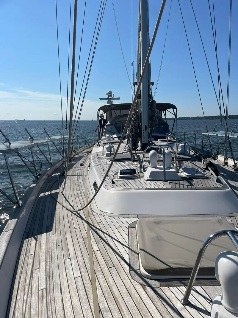 Slide: The Image of 2008 Hallberg-Rassy 62 yacht with teak deck sailing on open water. - 9