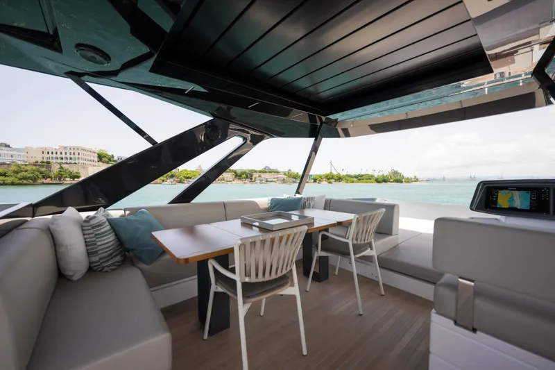 Slide: The Image of Luxurious 2023 Ferretti Yachts 720 interior with elegant seating and scenic ocean view. - 16