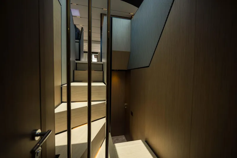 Slide: The Image of Interior staircase of 2023 Ferretti Yachts 720, featuring modern design and wood paneling. - 41