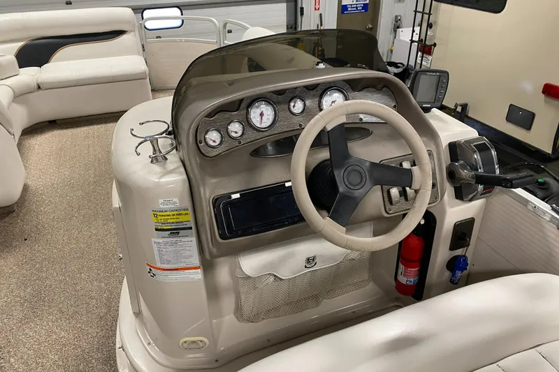 Slide: The Image of 2006 Premier 225 Legend boat dashboard with steering wheel and gauges. - 13