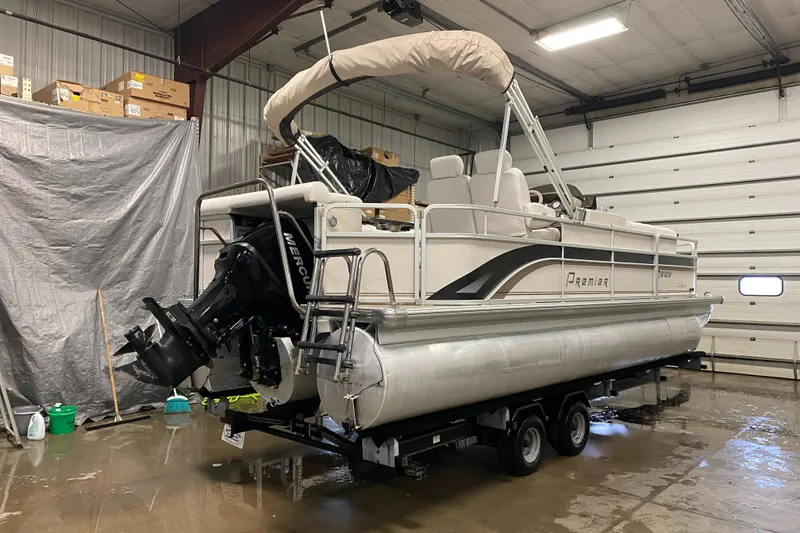 Slide: The Image of 2006 Premier 225 Legend pontoon boat in indoor storage on trailer. - 3