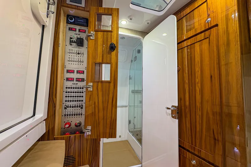 Slide: The Image of 2024 HCB 53' Suenos interior with control panel and wooden cabinetry. - 13