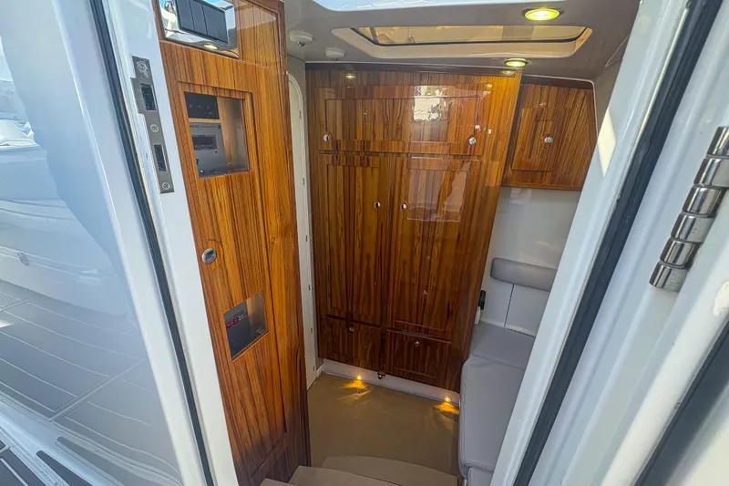 Slide: The Image of Luxurious interior of 2024 HCB 53' Suenos yacht with elegant wood paneling. - 23