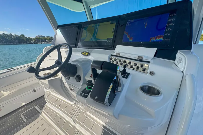 Slide: The Image of Helm of 2024 HCB 53' Suenos boat with advanced navigation displays. - 29
