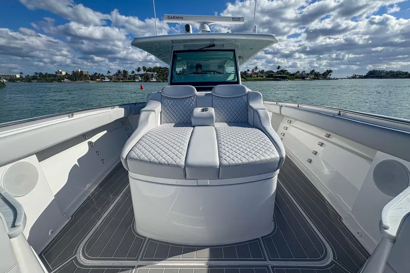 Slide: The Image of 2024 HCB 53' Suenos luxury boat interior with quilted seating, on a sunny day. - 31