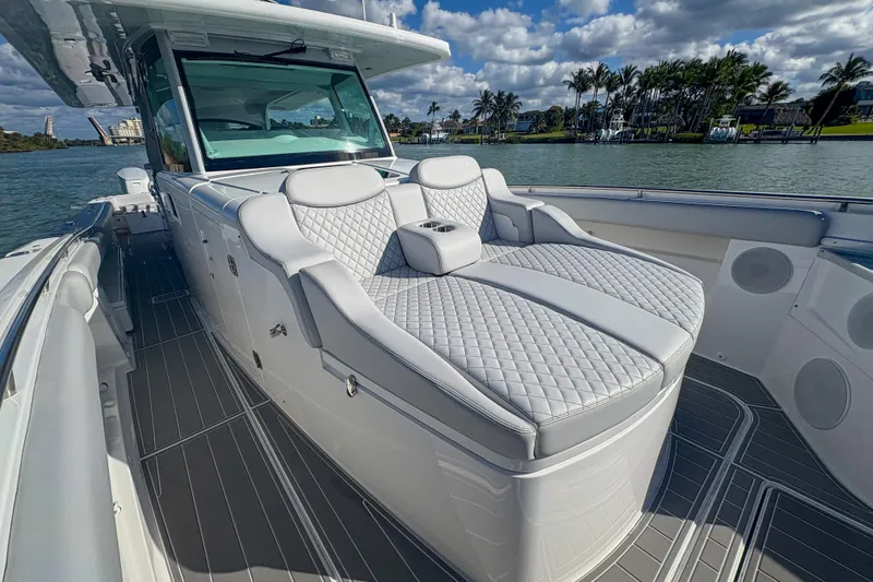 Slide: The Image of 2024 HCB 53' Suenos luxury boat with plush seating and sleek design on the water. - 33
