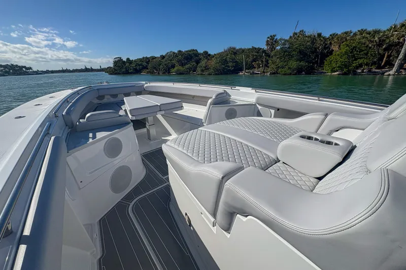 Slide: The Image of 2024 HCB 53' Suenos luxury boat interior with plush seating and scenic water view. - 38