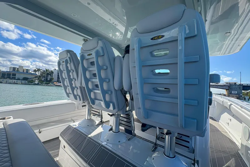 Slide: The Image of 2024 HCB 53' Suenos boat interior with luxurious seating and scenic waterfront view. - 41