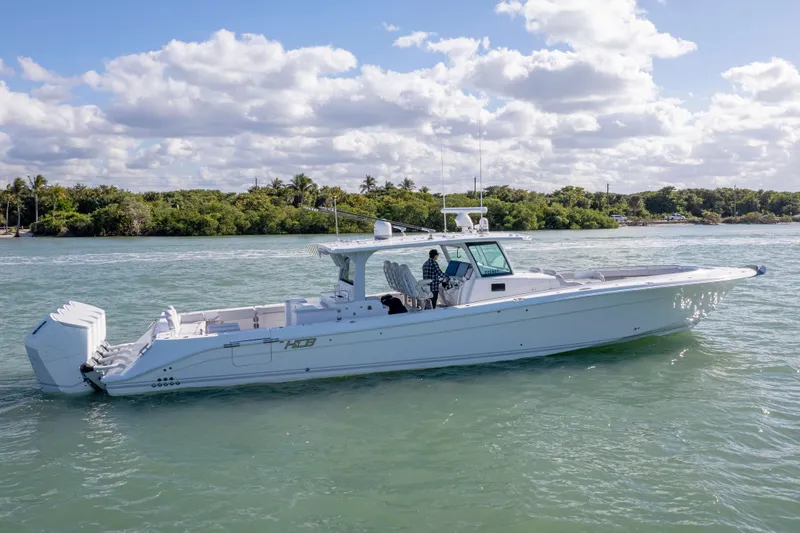 Slide: The Image of 2024 HCB 53' Suenos luxury boat cruising on a sunny day. - 59