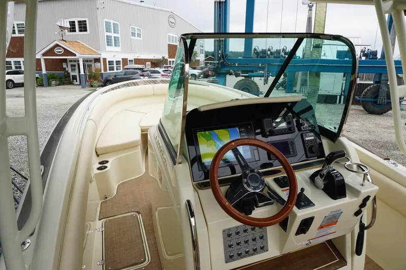 Slide: The Image of 2018 Chris-Craft Catalina 26 boat dashboard with steering wheel and navigation system. - 13