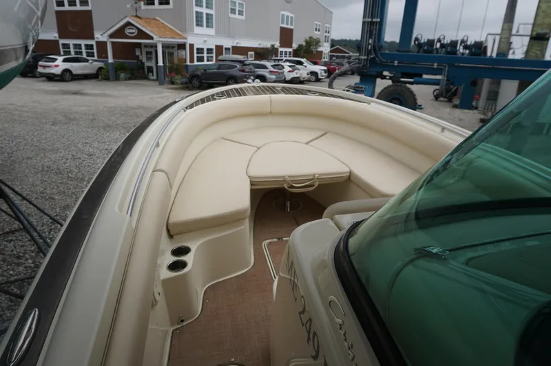 Slide: The Image of 2018 Chris-Craft Catalina 26 boat interior with beige seating and cup holders. - 14