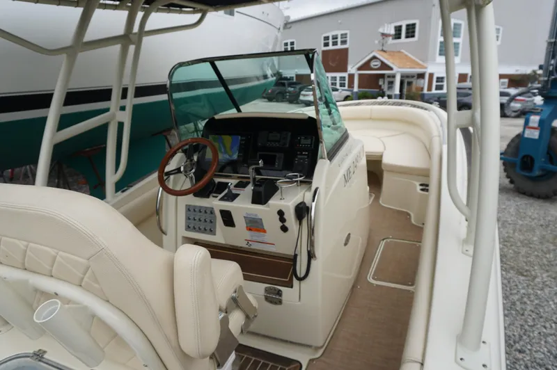 Slide: The Image of 2018 Chris-Craft Catalina 26 boat interior with helm and seating area. - 2