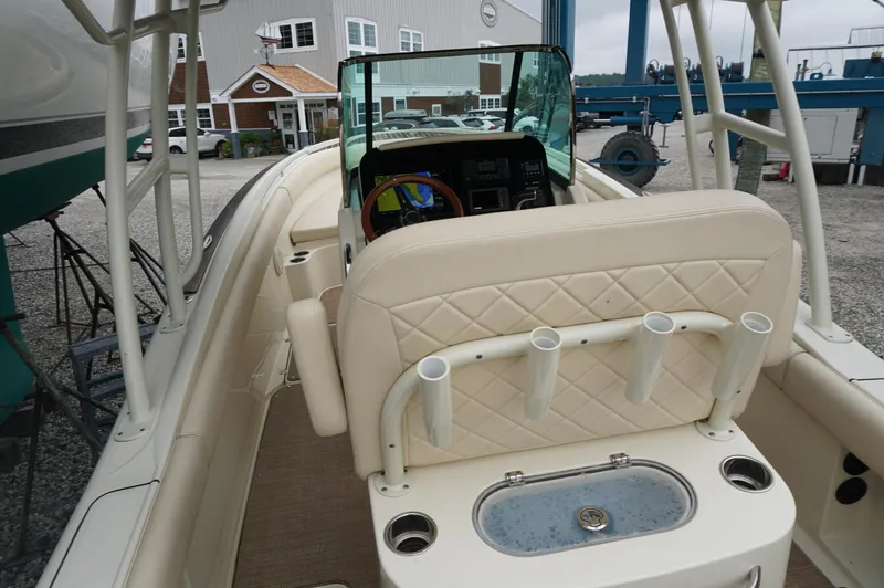 Slide: The Image of 2018 Chris-Craft Catalina 26 boat interior with beige seating and rod holders. - 4