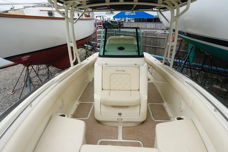 Slide: The Image of 2018 Chris-Craft Catalina 26 boat interior with beige seating and windshield. - 8