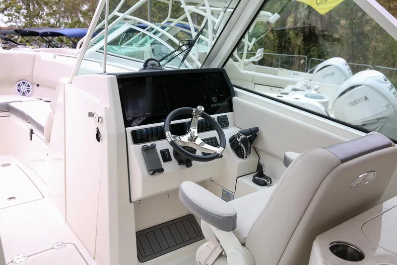 Slide: The Image of 2025 Sailfish 276 DC boat cockpit with modern steering and controls. - 5