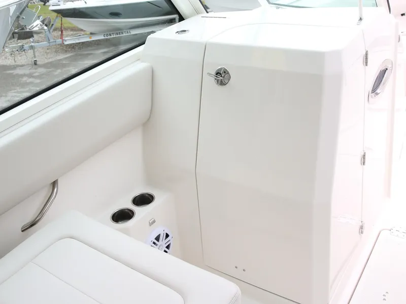 Slide: The Image of 2025 Sailfish 276 DC interior with white seating, cup holders, and sleek design. - 6
