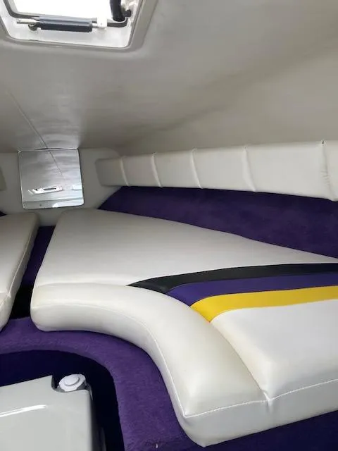 Slide: The Image of Interior of 2003 Caravelle 232 Cuddy Interceptor with white and purple upholstery. - 10