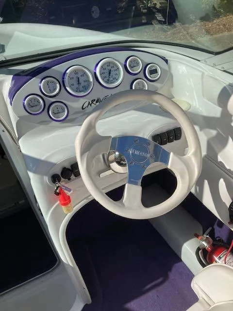 Slide: The Image of 2003 Caravelle 232 Cuddy Interceptor dashboard with steering wheel and gauges. - 12