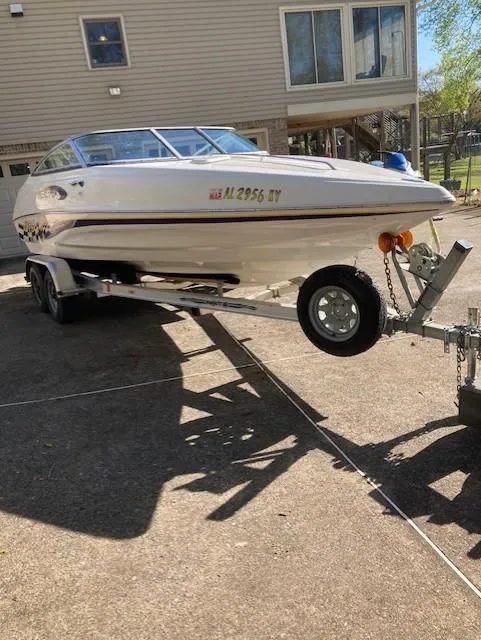 Slide: The Image of 2003 Caravelle 232 Cuddy Interceptor boat on trailer, parked in driveway. - 4