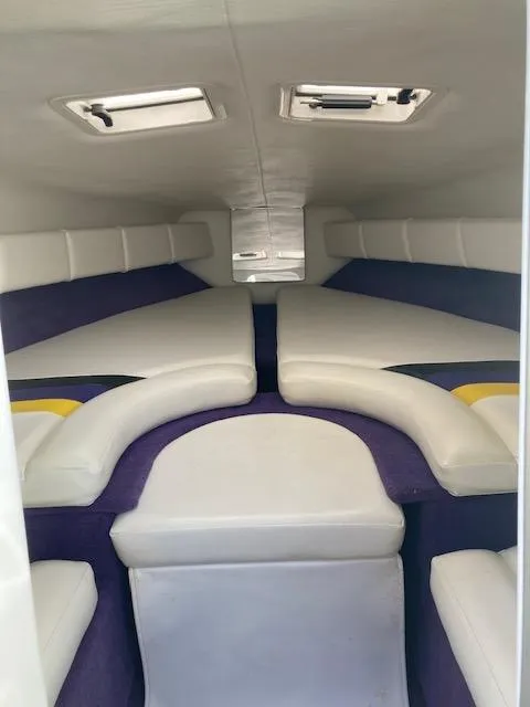 Slide: The Image of Interior of 2003 Caravelle 232 Cuddy Interceptor with white and purple seating. - 7