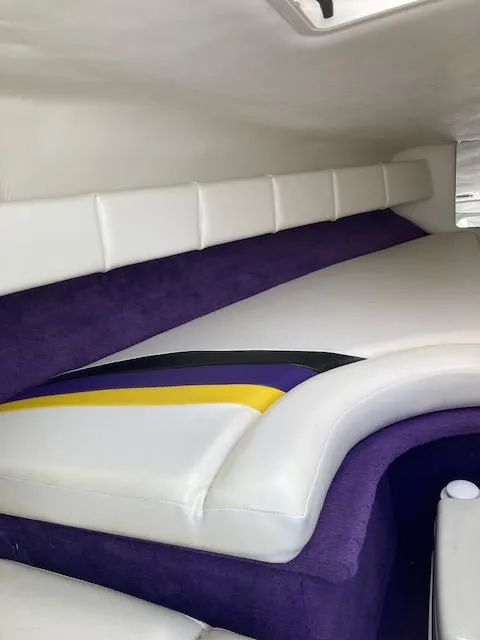 Slide: The Image of Interior of 2003 Caravelle 232 Cuddy Interceptor with white and purple upholstery. - 9