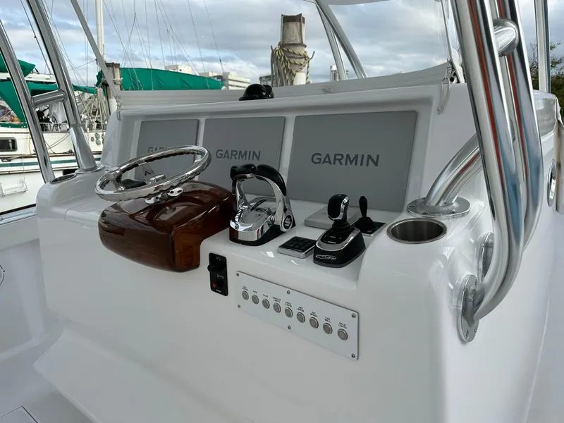 Slide: The Image of 2022 Weaver Center Console boat dashboard with Garmin displays and controls. - 10