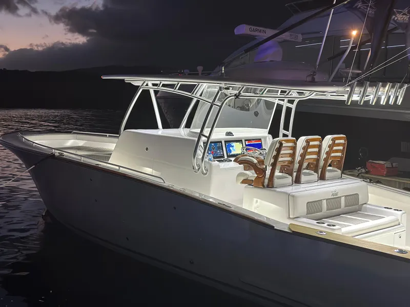 Slide: The Image of 2022 Weaver Center Console boat illuminated at night, docked on calm water. - 11