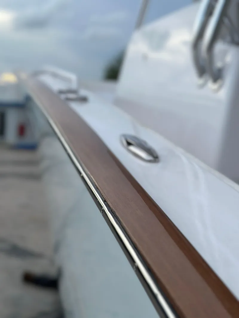 Slide: The Image of 2022 Weaver Center Console boat with sleek wooden trim and polished metal details. - 13