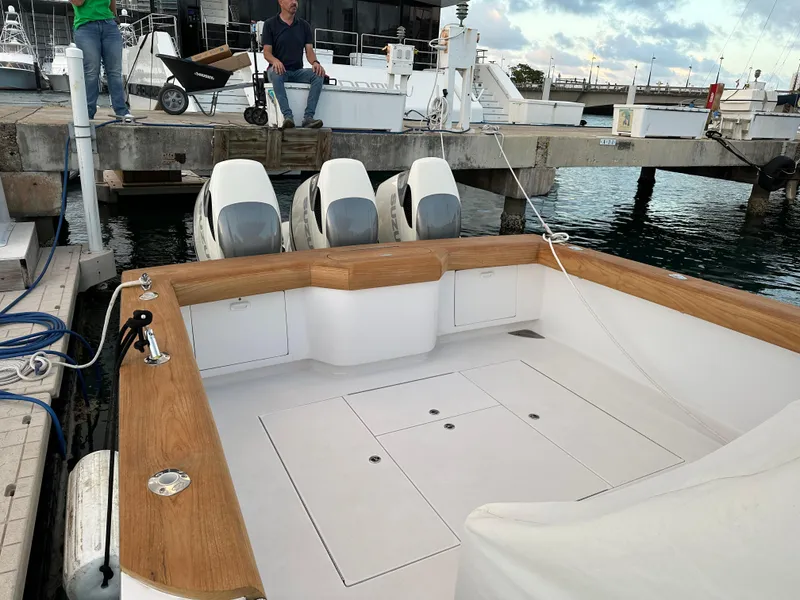 Slide: The Image of 2022 Weaver Center Console boat docked with triple outboard engines. - 7