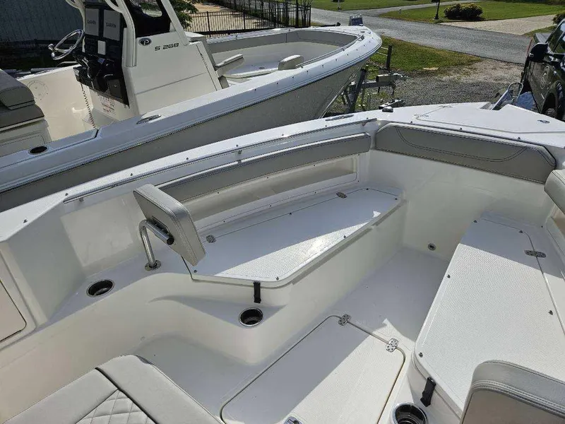 Slide: The Image of 2024 Pursuit S 248 Sport boat interior with seating and storage. - 12