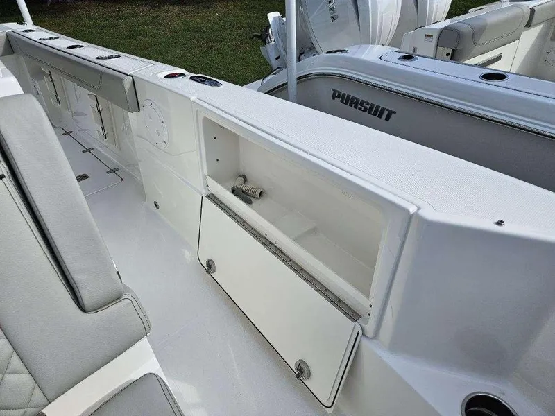 Slide: The Image of 2024 Pursuit S 248 Sport boat interior with storage compartment and seating. - 15