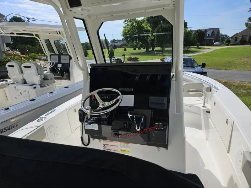 Slide: The Image of 2024 Pursuit S 248 Sport boat interior with steering console and seating. - 16