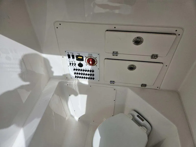 Slide: The Image of 2024 Pursuit S 248 Sport boat interior with control panel and storage compartments. - 17