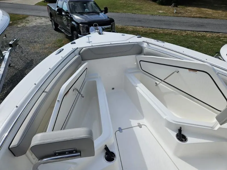 Slide: The Image of 2024 Pursuit S 248 Sport boat interior with seating and storage compartments. - 18