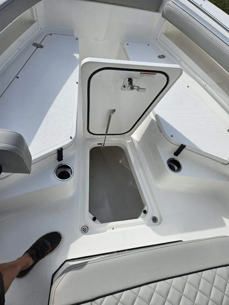 Slide: The Image of 2024 Pursuit S 248 Sport boat interior with open storage compartment. - 19
