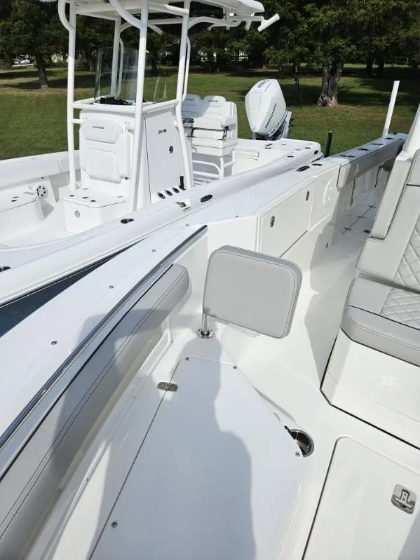 Slide: The Image of 2024 Pursuit S 248 Sport boat interior with white seating and console. - 20