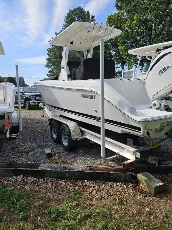 Slide: The Image of 2024 Pursuit S 248 Sport boat on trailer, parked outdoors. - 3