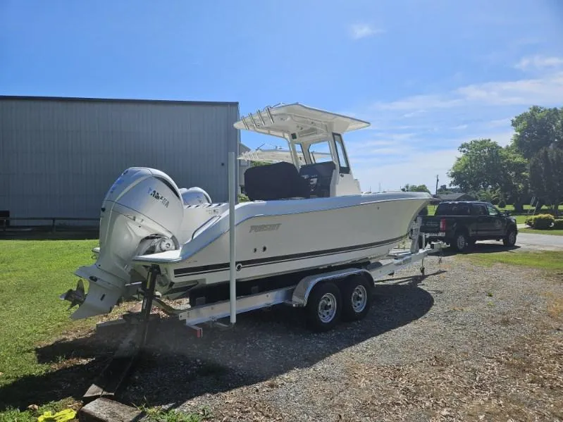 Slide: The Image of 2024 Pursuit S 248 Sport boat on trailer, parked outdoors under clear sky. - 4