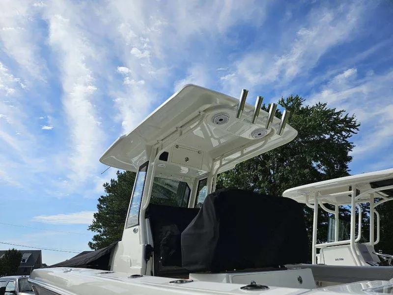 Slide: The Image of 2024 Pursuit S 248 Sport boat under a clear blue sky. - 7