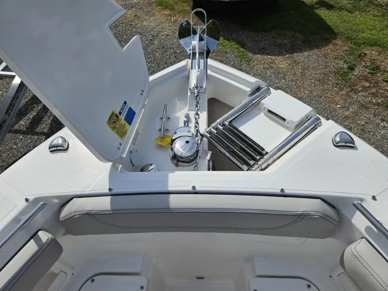 Slide: The Image of 2024 Pursuit S 248 Sport boat anchor compartment with open hatch. - 9