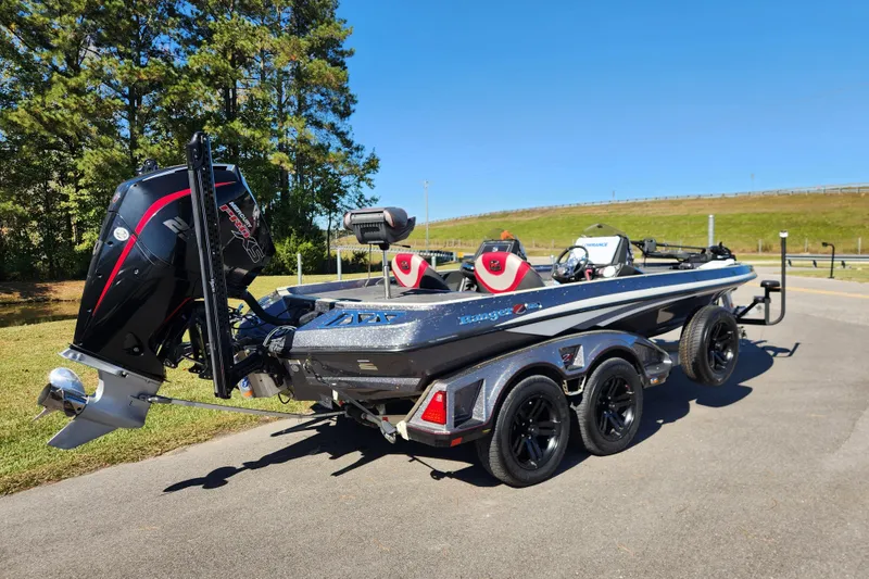 Slide: The Image of 2019 Ranger Z520L boat with powerful outboard motor on a trailer, parked outdoors. - 2