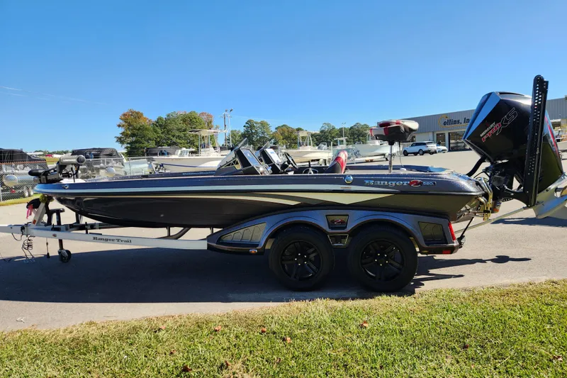 Slide: The Image of 2019 Ranger Z520L bass boat on trailer, parked outdoors under clear blue sky. - 5