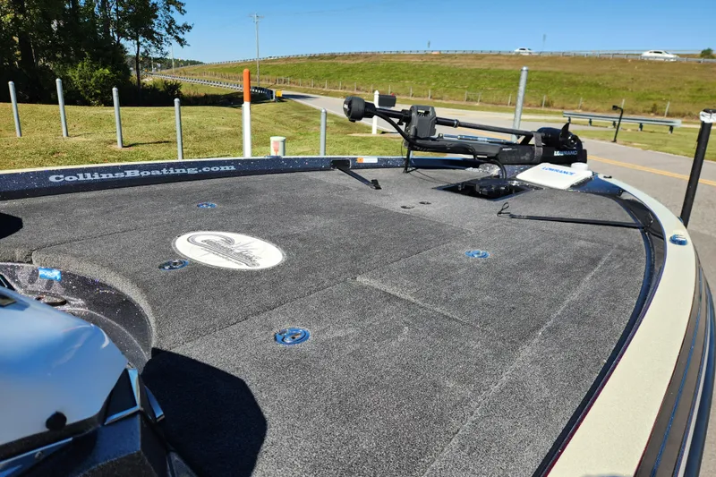 Slide: The Image of 2019 Ranger Z520L boat deck with fishing equipment, parked near a road. - 9