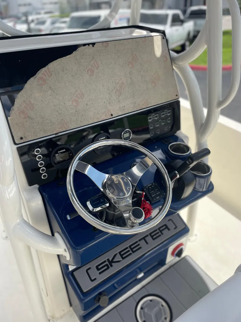 Slide: The Image of 2024 Skeeter SX 2350 boat console with steering wheel and controls. - 12