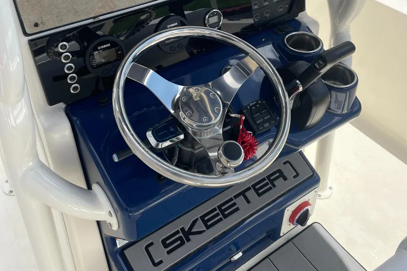 Slide: The Image of 2024 Skeeter SX 2350 boat dashboard with steering wheel and controls. - 14