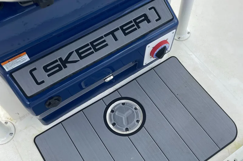 Slide: The Image of 2024 Skeeter SX 2350 boat deck with logo and control panel. - 18