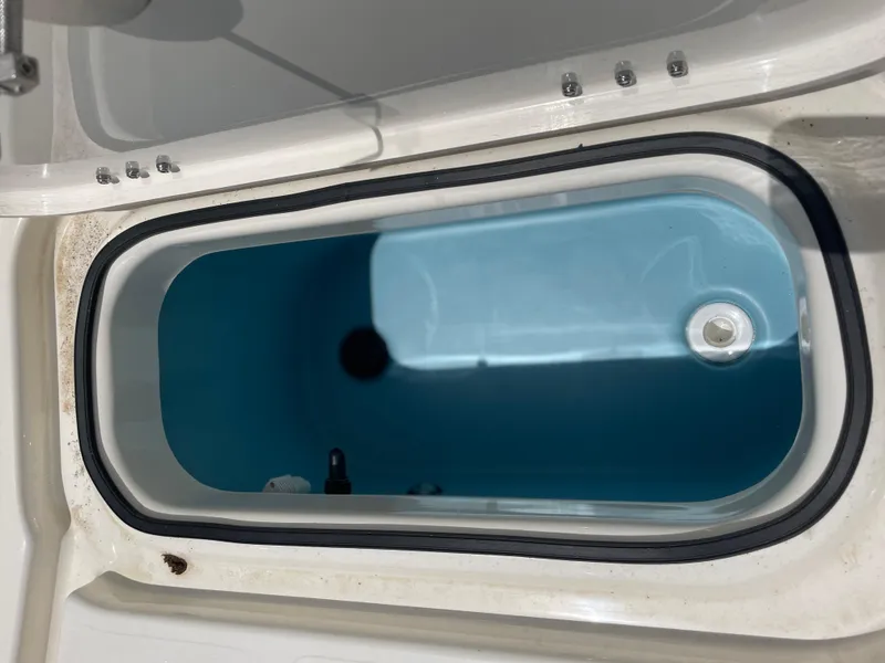 Slide: The Image of 2024 Skeeter SX 2350 livewell with blue interior and secure lid. - 22
