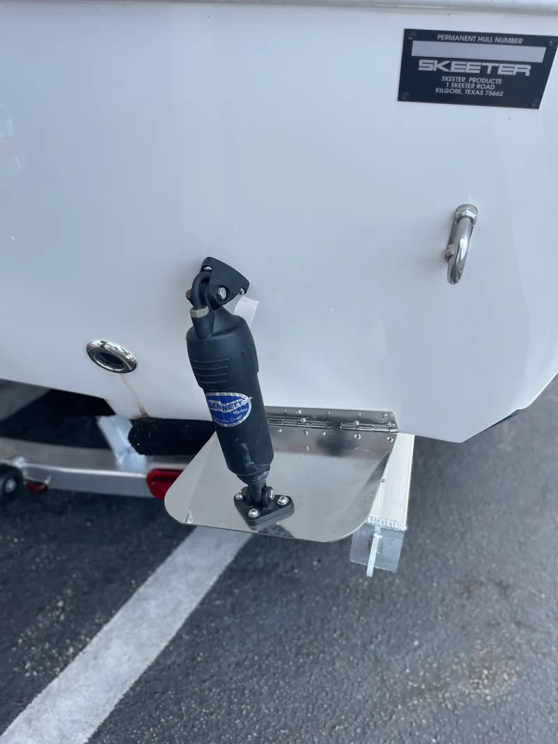 Slide: The Image of 2024 Skeeter SX 2350 boat transom with trim tab and hydraulic actuator. - 25