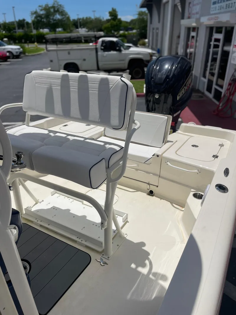 Slide: The Image of 2024 Skeeter SX 2350 boat interior with seating and motor, parked outdoors. - 3
